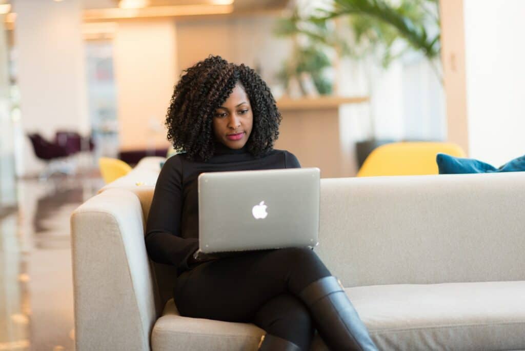 Woman Using Macbook Sitting on White Couch, digital marketing, content